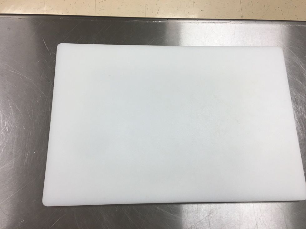 Place your cutting board of your choice on your table.