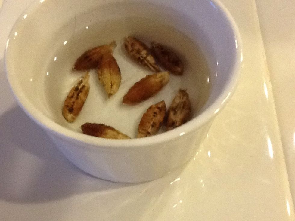 Place your date seeds in a small dish covered with cool water.  Soak them for one week, changing the water at least once a day to keep mold from forming.