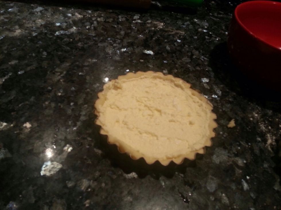 Place your dough into a pastry mould and add the cheese mixture