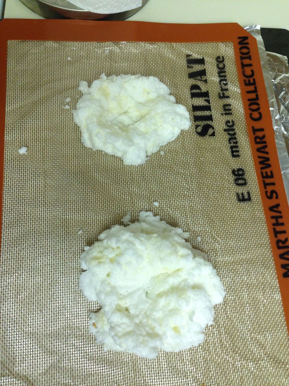 Place your egg white mixture onto your baking sheet. Form into two little nests with a depression in the middle of each for the yolks.