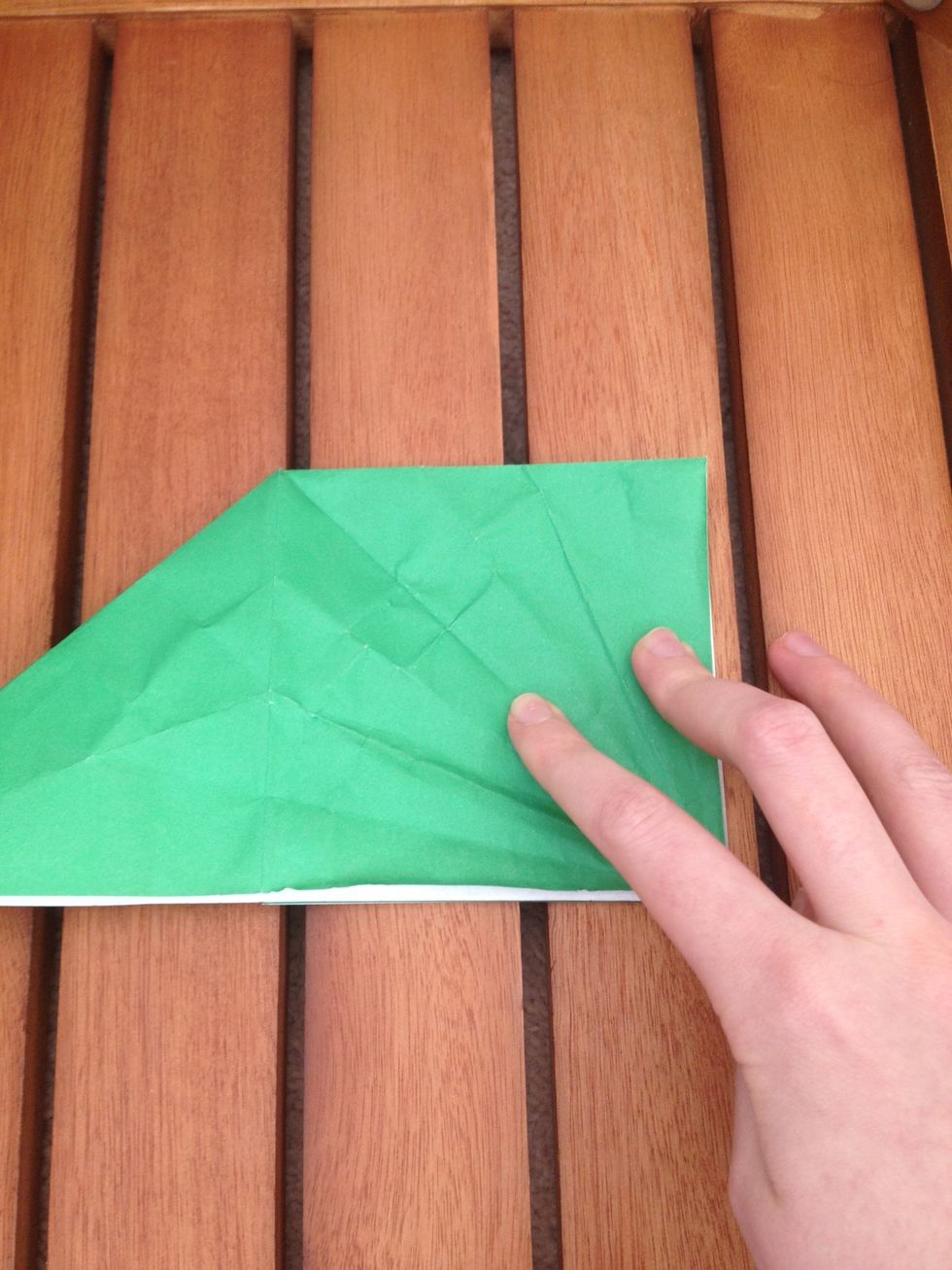 Place your finger on the crease down the middle of the square side.