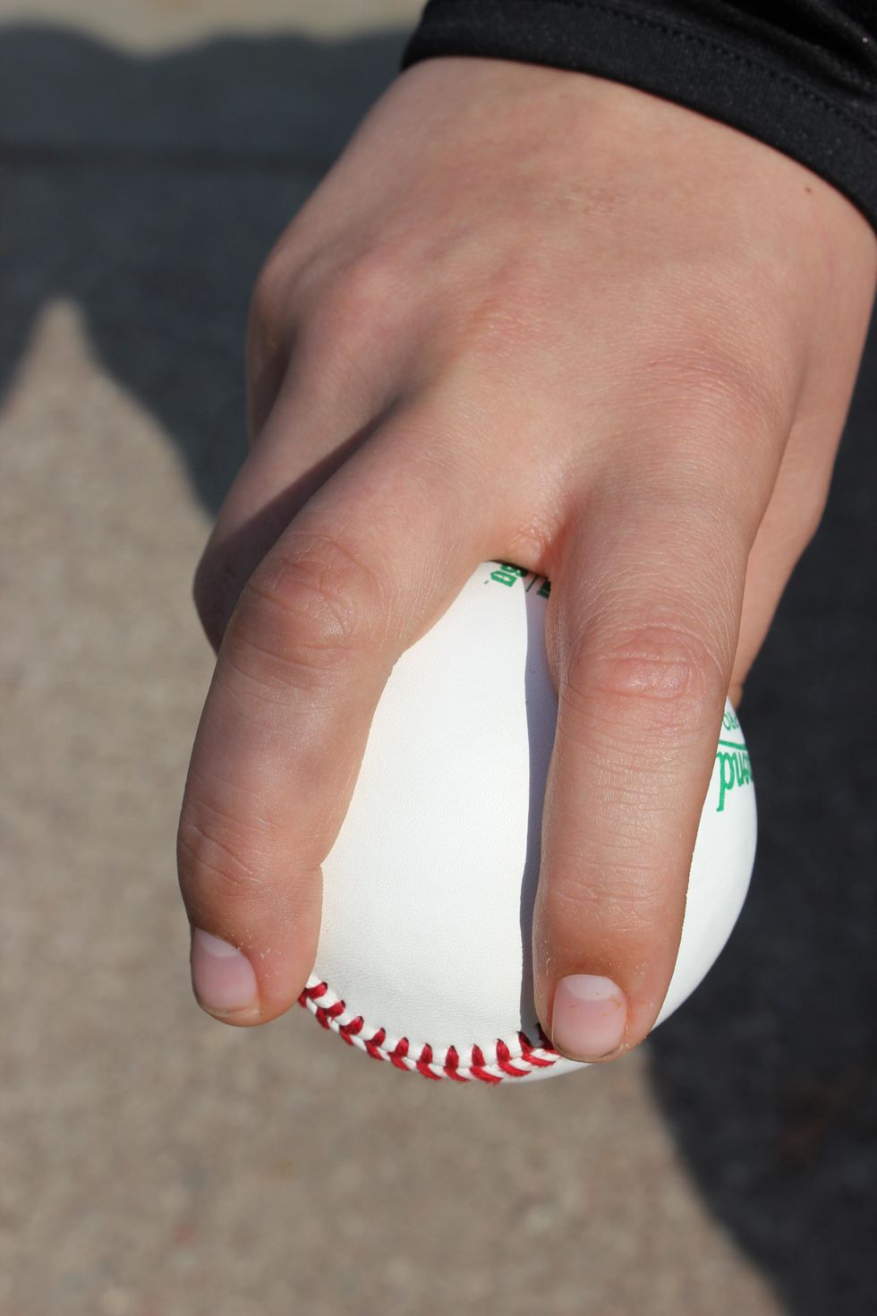 Place your fingers on the two seams just before the point where the seams round off