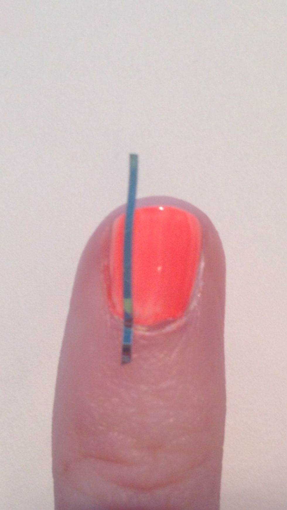 Place your first piece of striping tape on your nail vertically about a quarter down your nail. (If that makes sense? Lol)