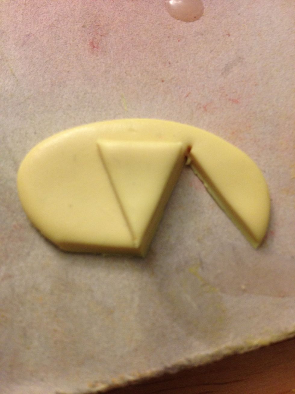 Place your first triangle on top of the clay to make sure all of the slices are the same size.