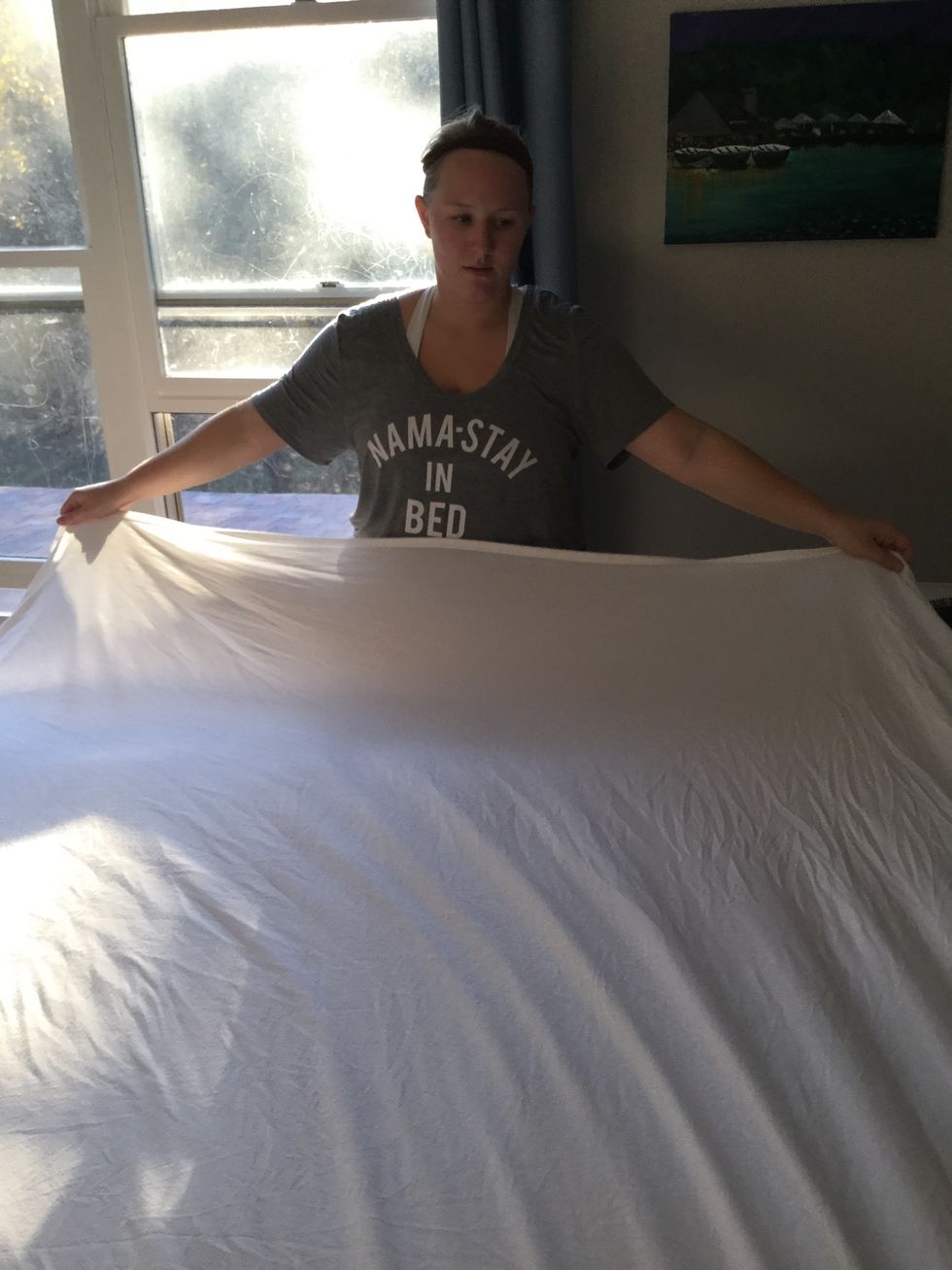 Place your flat sheet over the fitted sheet and lay flat