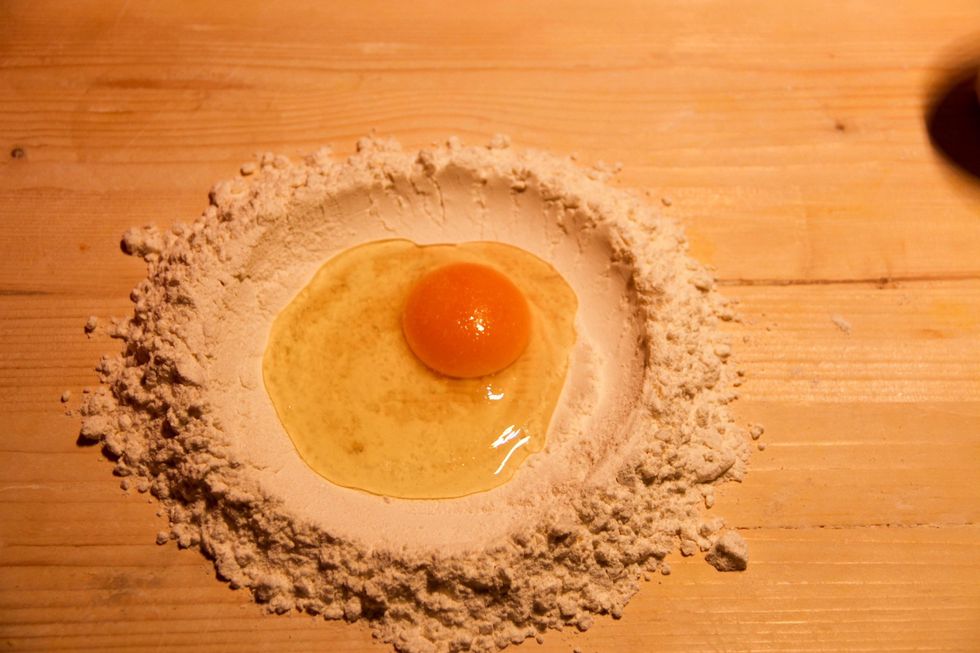 Place your flour on table and make hole in center and break inside your egg. Add a pinch of salt.