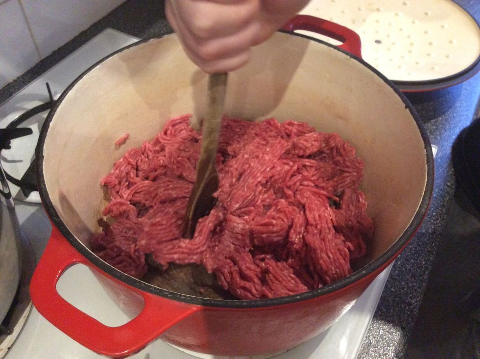 Place your ground beef in the pot and break up the meat.