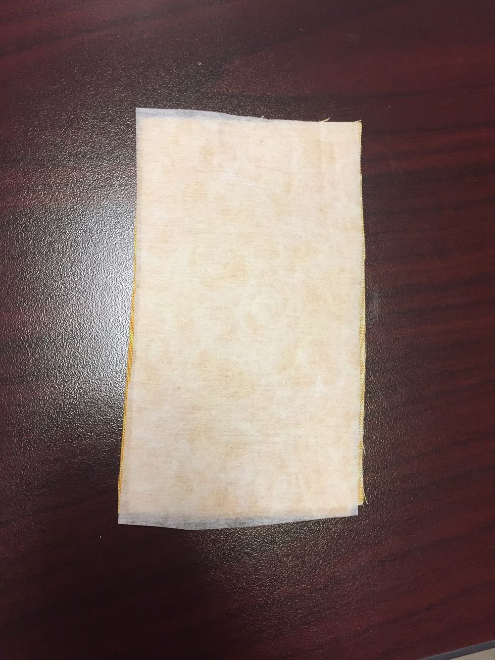 Place your material right sides together and cut a 2.5x4.5 rectangle. Pin the rectangle to the interfacing (glue side to the wrong side of one of pieces of fabric) and cut an equal sized rectangle.