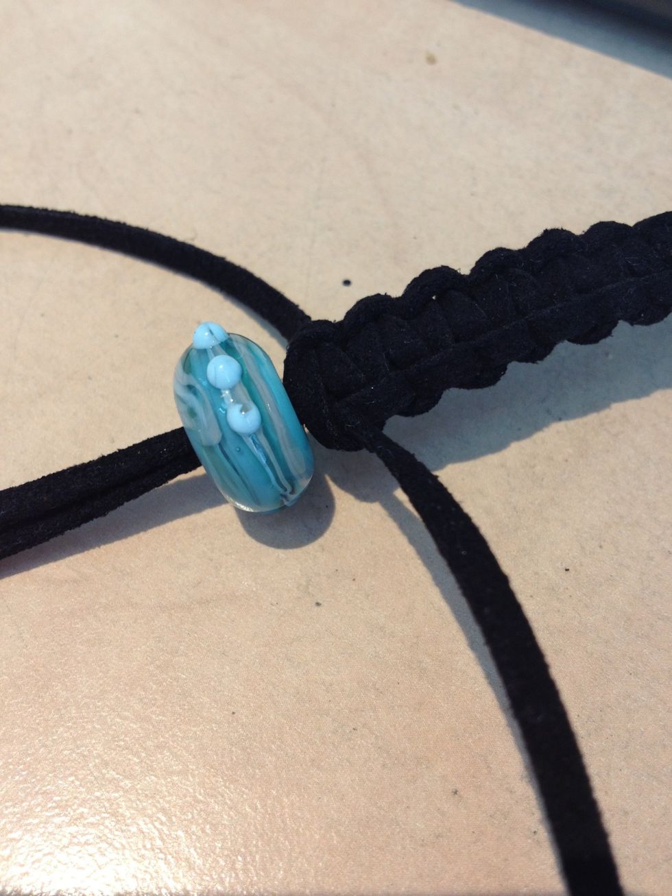 Place your Nalu Bead around the middle thong.