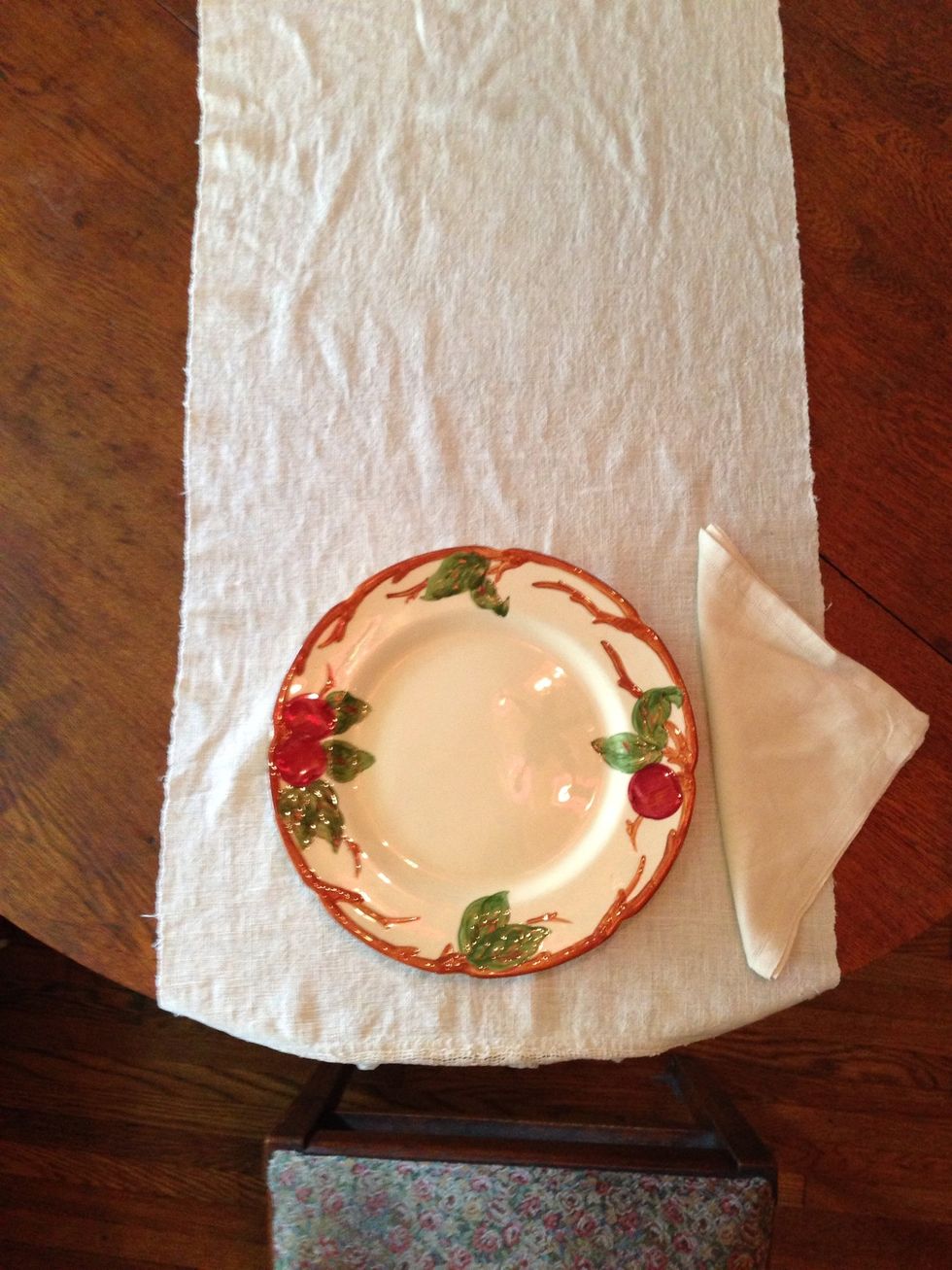 Place your napkin to the right of the plate. There are many ways to fold a napkin here on Snapguide. I chose a simple triangle fold.