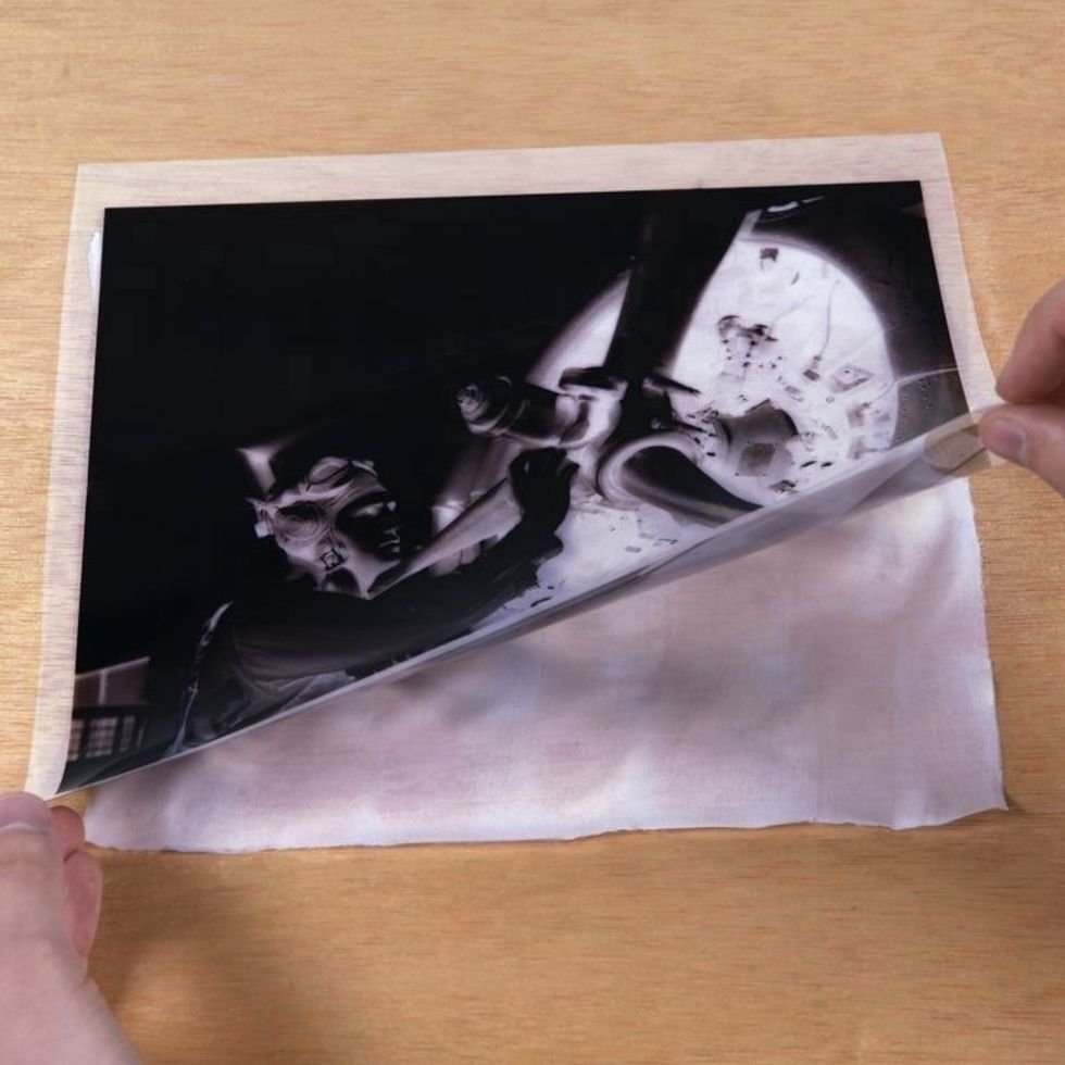 Place your negative on top of the coated silk. If you're using an inkjet negative, place the waterproof side down (printed side up) so the printed ink doesn't transfer to your coated material.