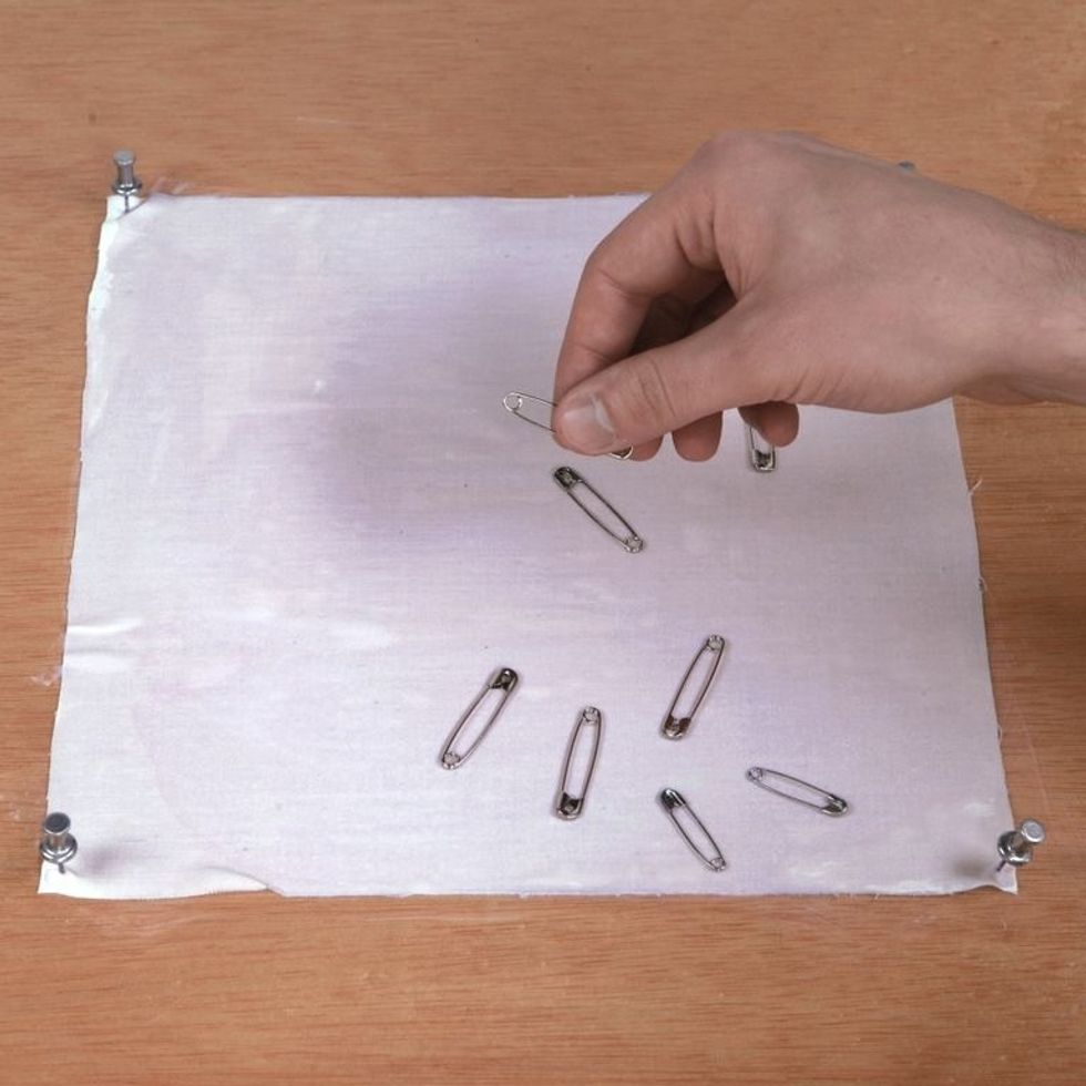 Place your objects on the coated cotton. It's best to choose objects that lay flat on your material to avoid shadows. Objects that are lifted from the surface may appear fuzzy in the final print.