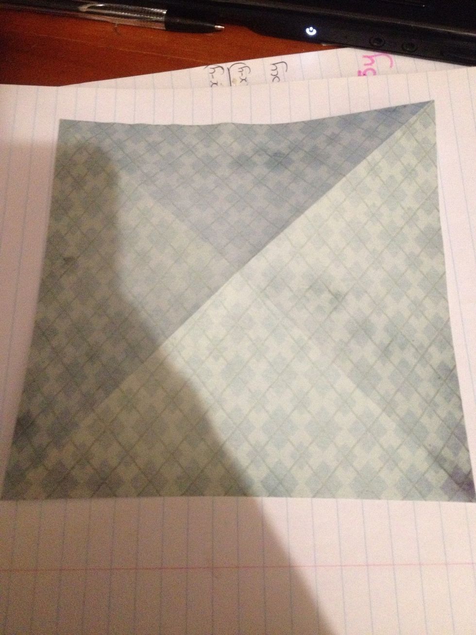 Place your origami paper on a flat surface