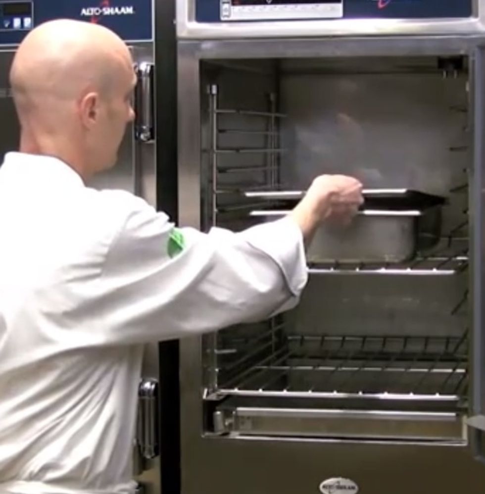 Place your pan of creme brulees into the cook and hold and place a cover over the pan.