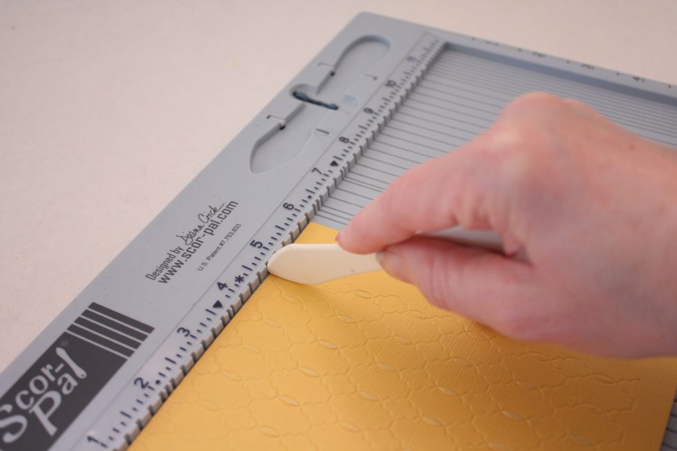 Place your paper face down on your scor-pal and score in 1.75 inches on each side. If you don't have a score pal just use your ruler as a folding guide