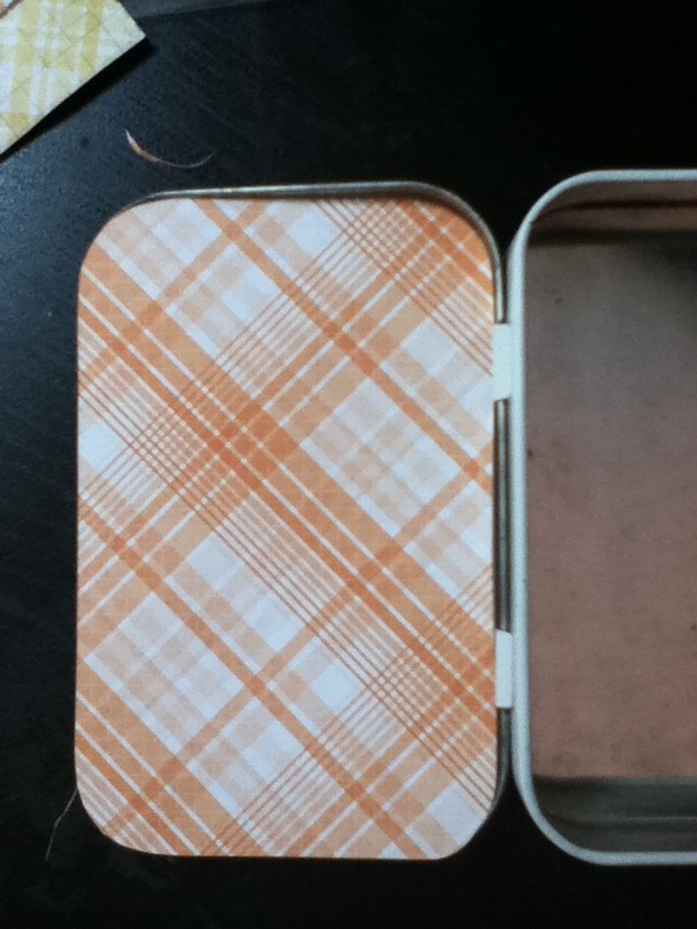 Place your paper in the inside cover of your tin. It won't quite fit snugly inside; it will be slightly too big. Slowly trim it down until......