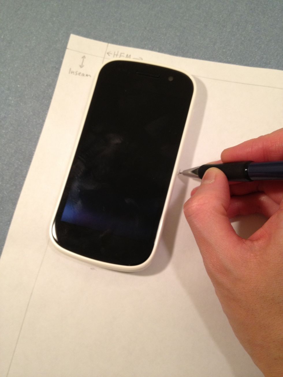 Place your phone down on the piece of paper (aligning it with your previously made lines) and mark the right side and the bottom side onto the template paper.