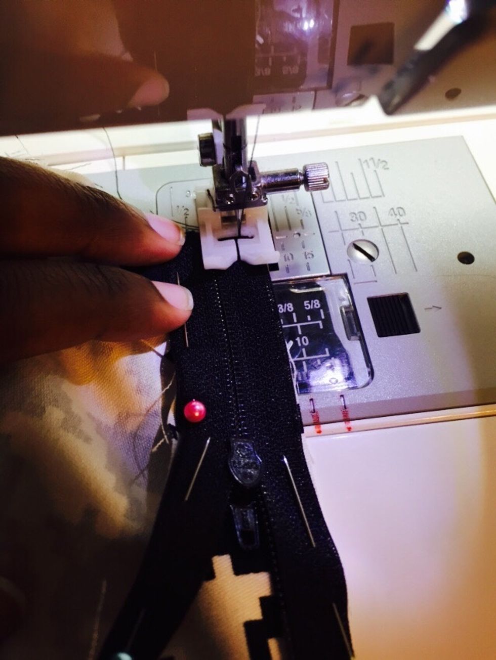 Place your pinned zipper under your sewing machine and began to sew it to each side. Remove pins as you sew along. *Remember to back stitch at the beginning and end.