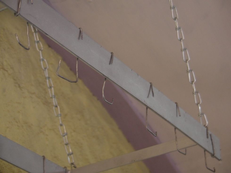 Place your pot hooks over the top of the steel bar.