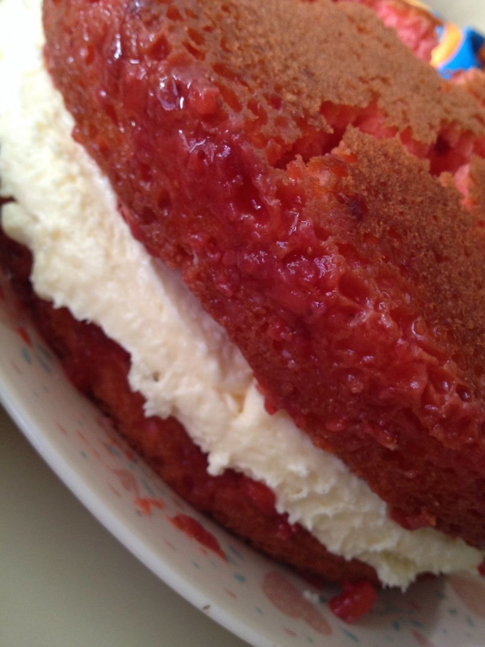 Place your second round on top of the cheesecake layer pur\u00e9e side down. Truthfully, your cake will probably crack a bit. Don't worry, the cracks will be filled in with your topping.