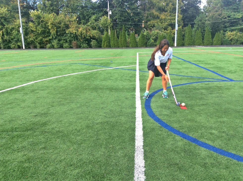 Place your stick directly behind the ball, so that the stick is barely touching the ball.