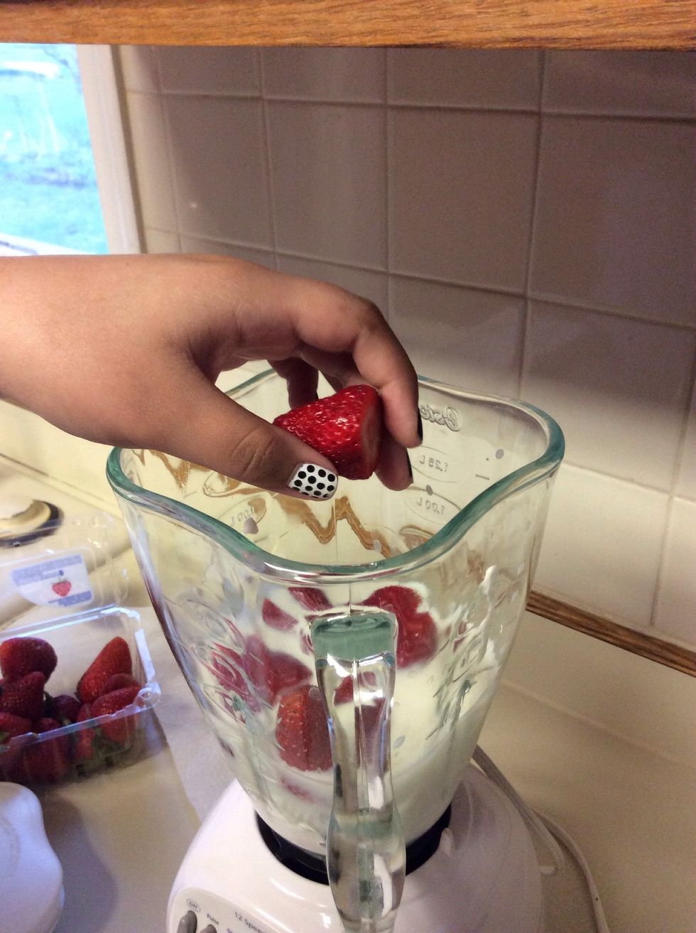 Place your strawberries in the blender.