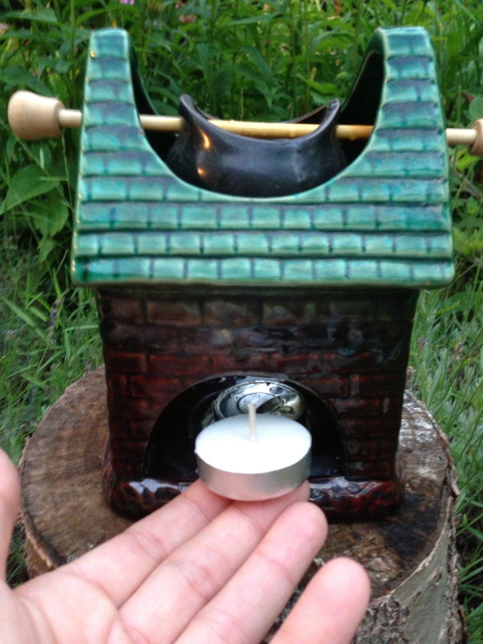 Place your tea light underneath the reservoir