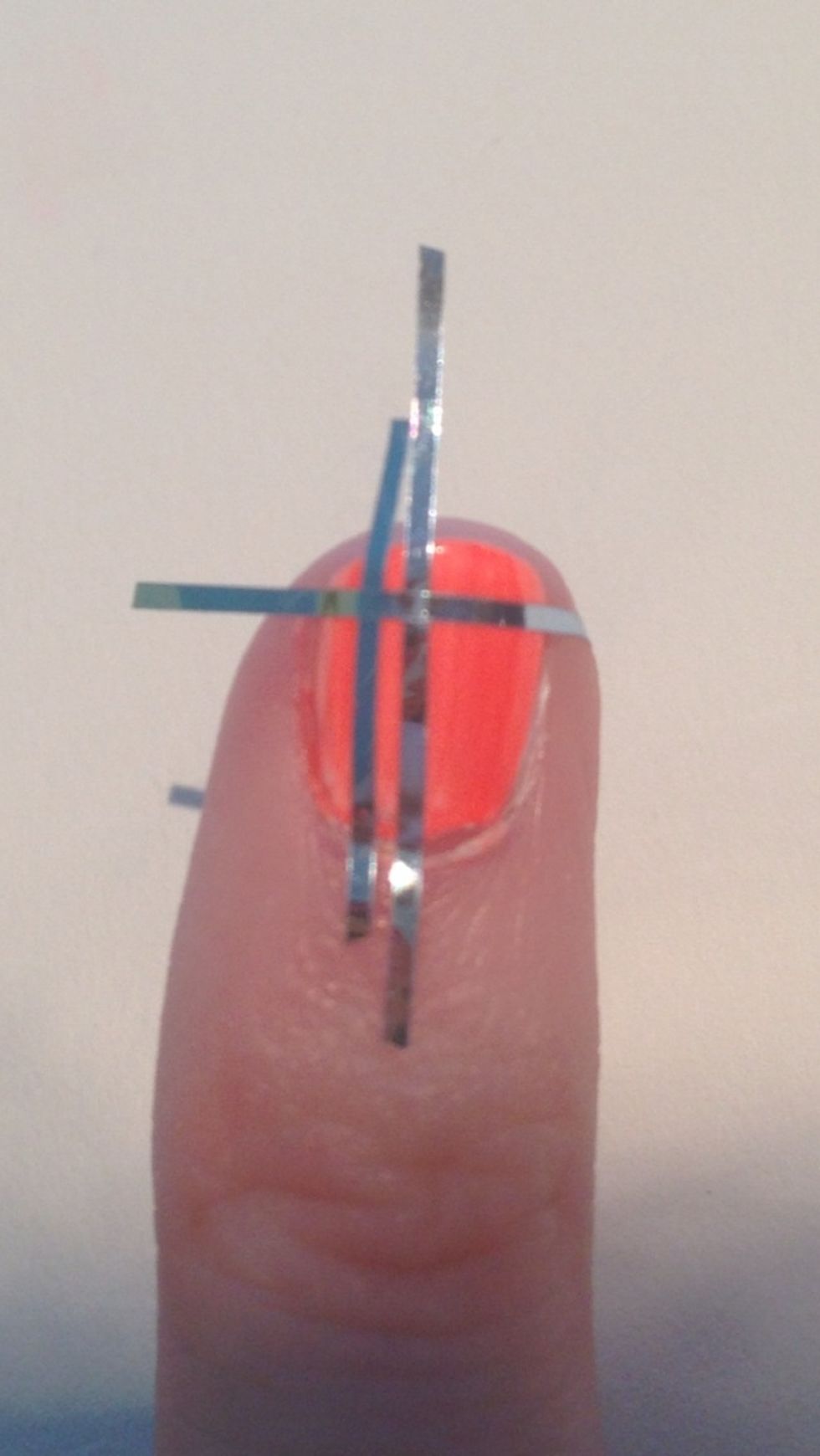 Place your third piece of tape horizontally leaving a little room by the tip.