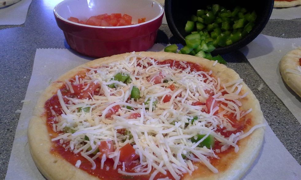 Place your toppings of choice. We like fresh vegetables. Spread a little more cheese over the toppings.