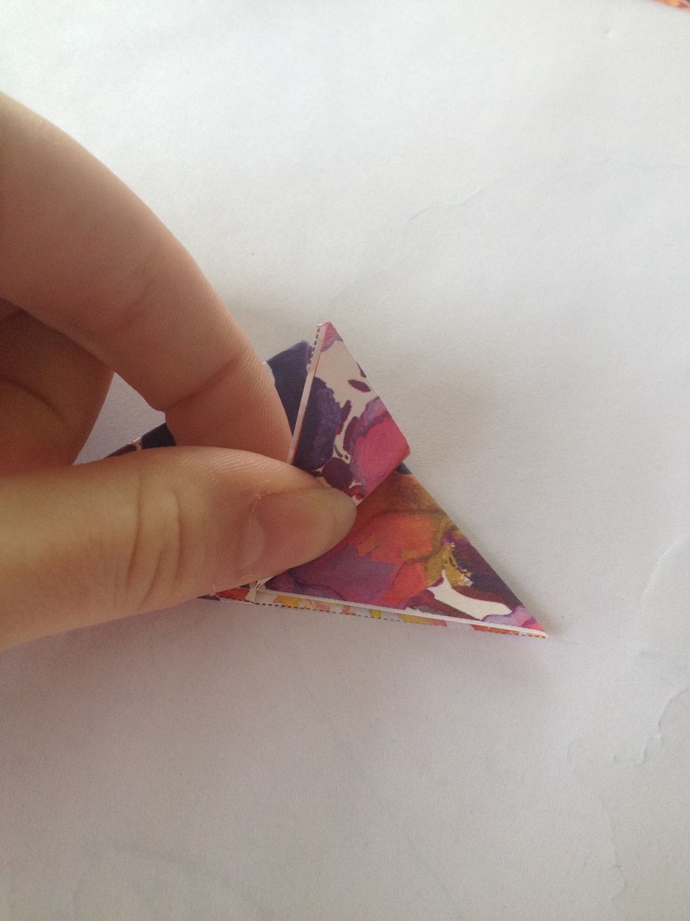 Place your triangle on its back, take the to points at the bottom of the triangle and fold the two points towards the top point