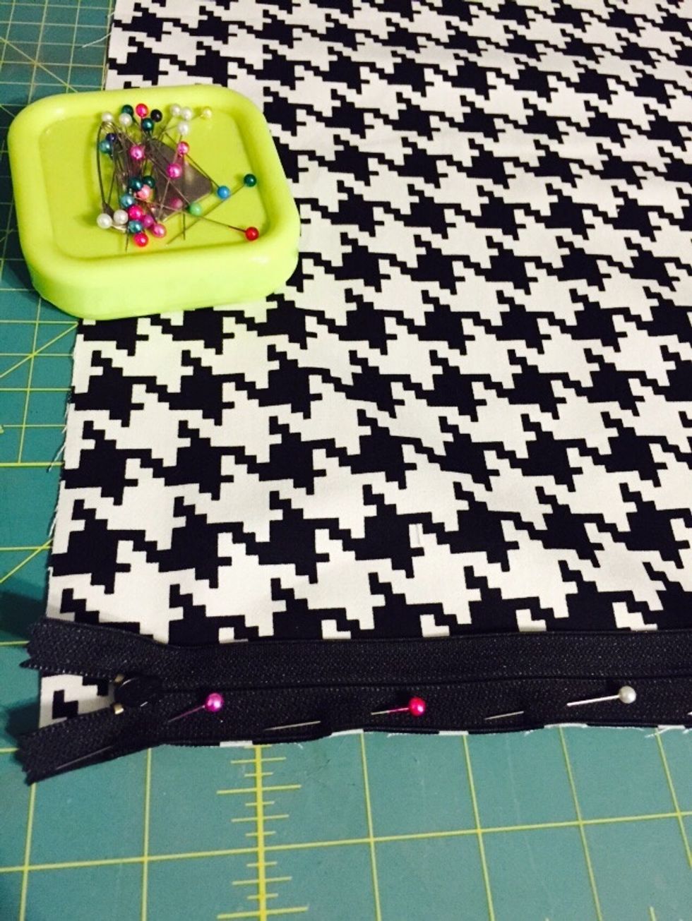 Place zipper teeth side down on right side of fabric and pin.