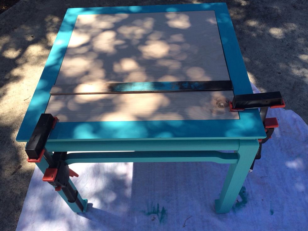 Placed board in place and used clamps to secure while glue dried
