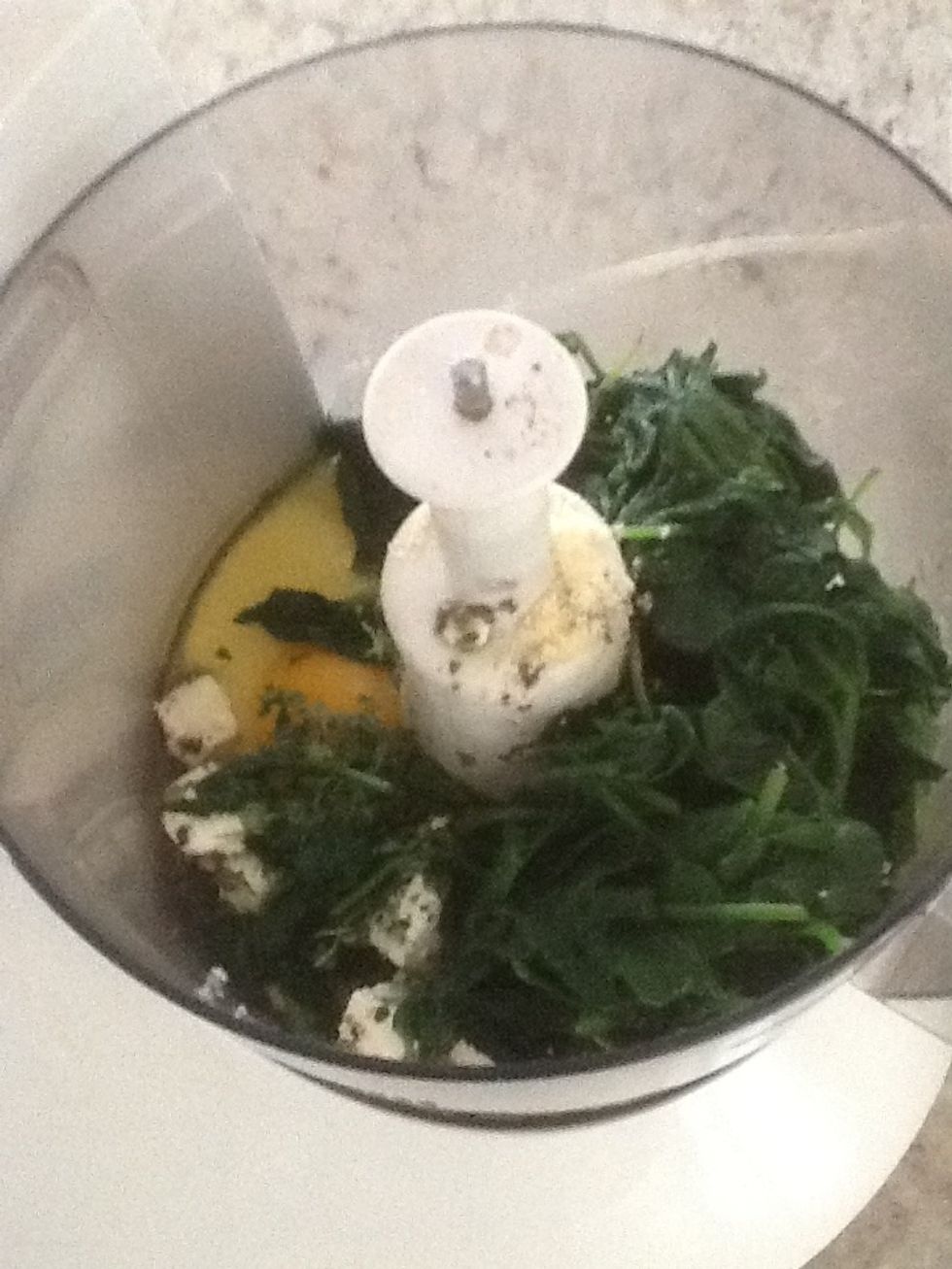 Placing the Wilted spinach, feta, Parmesan, egg, thyme in the food processor