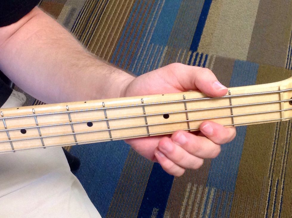 Placing your finger between the first and second frets will make A, the seventh note in the scale.