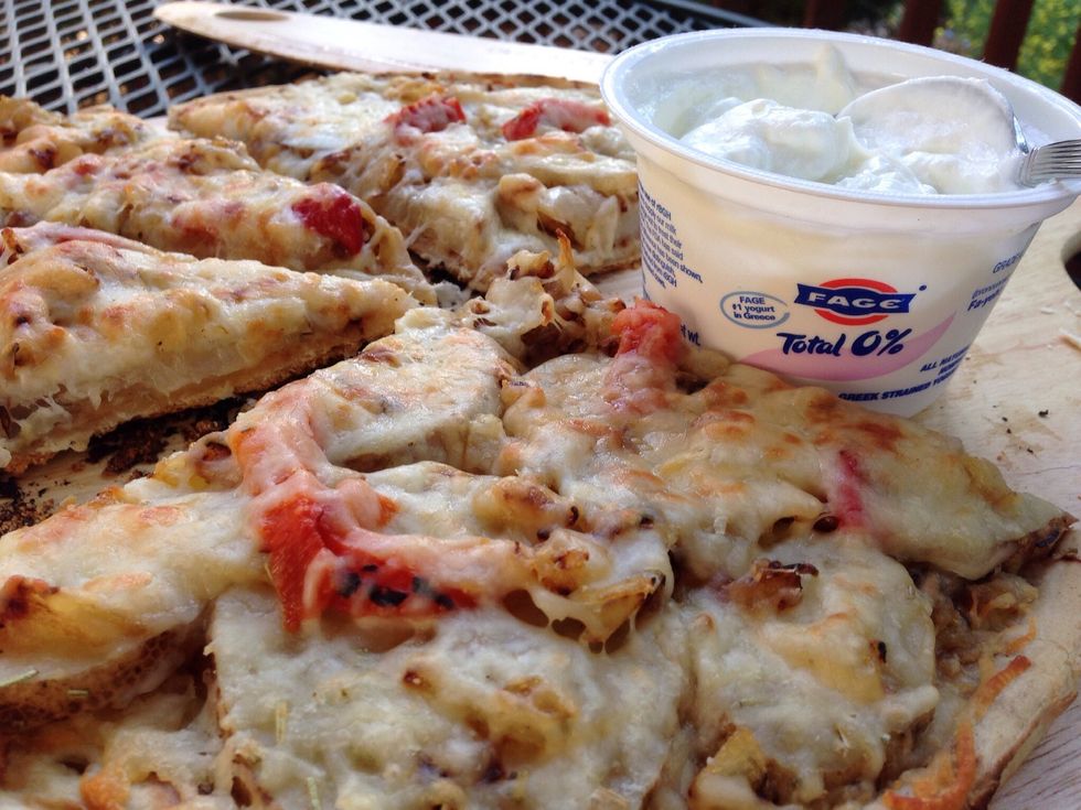 Plain Fage yogurt makes an excellent substitute for sour cream to dip your pizza slice into.