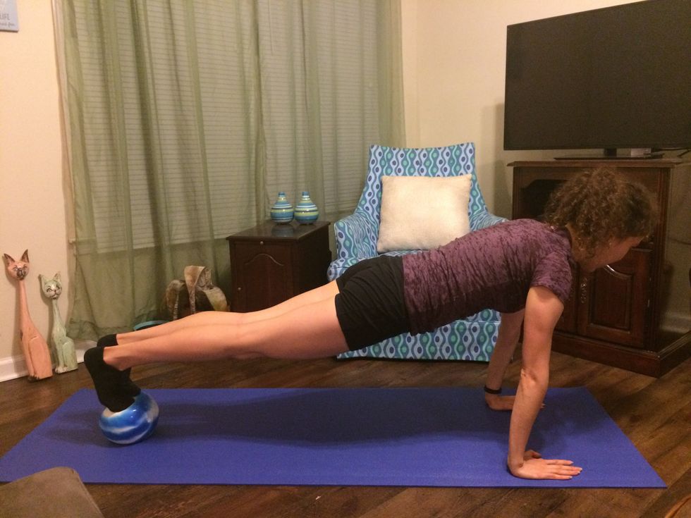 Plank Toe Taps: Get in the plank position with your feet balancing on the ball.