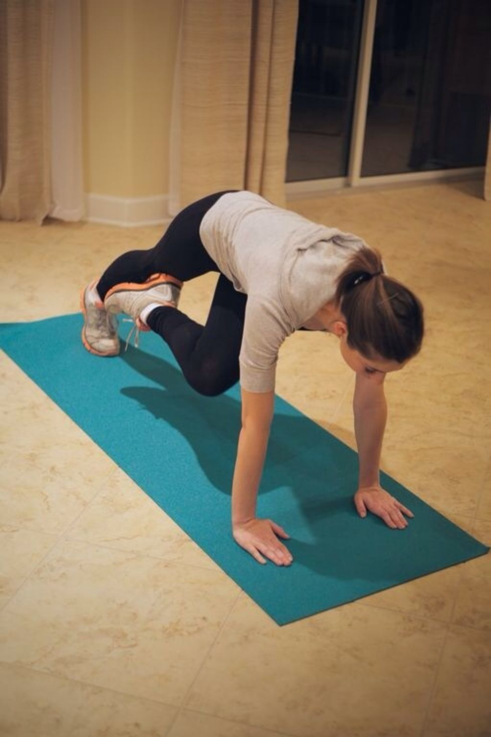 Plank Tuck: Lift left leg towards right arm, then bring back to starting.