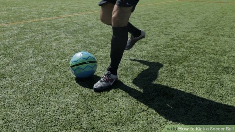 Plant the foot your not kicking with the way you want the ball to go