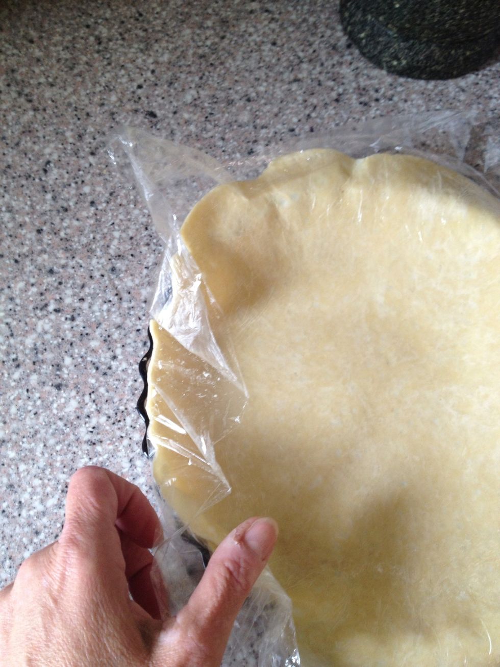Plastic wrap on top. The dough will stick to the wrap so it is not hard.