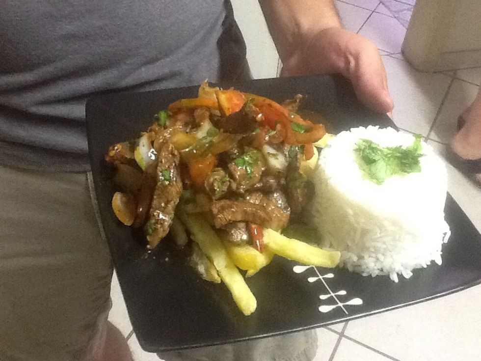 Plate up and enjoy! Use small cups to form the cooked rice, place French fries as a base, and then add the cooked ingredients, with some more chopped cilantro as decoration. Buen apetito!