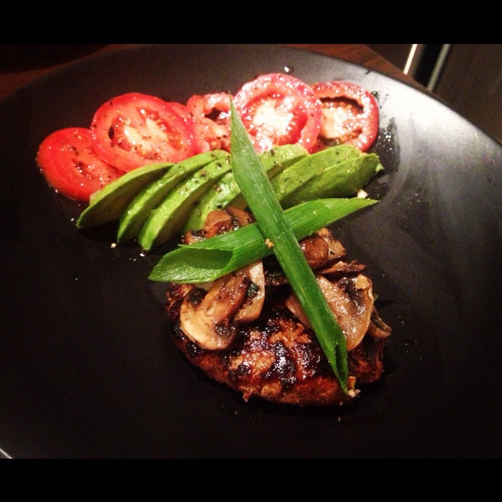 Plate your Asian Turkey Burger with a nice side of fresh Avocado and Tomato slices. Garnish with Green Onions. Top the veggies with lime juice, salt and pepper. Enjoy!