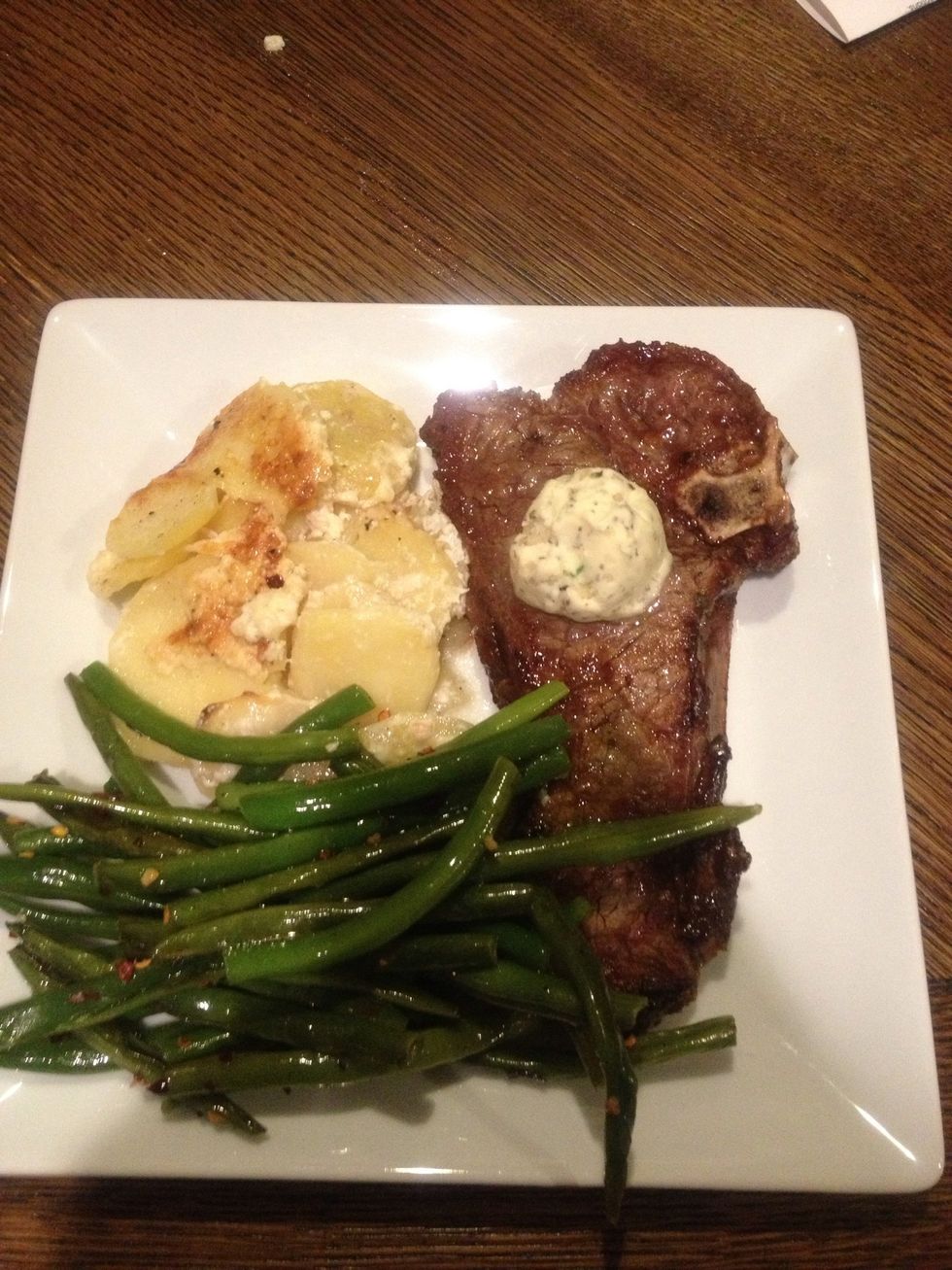 Plate your steak dinner placing pat of herbed butter onto steak to begin melting. Bon Apetite!
