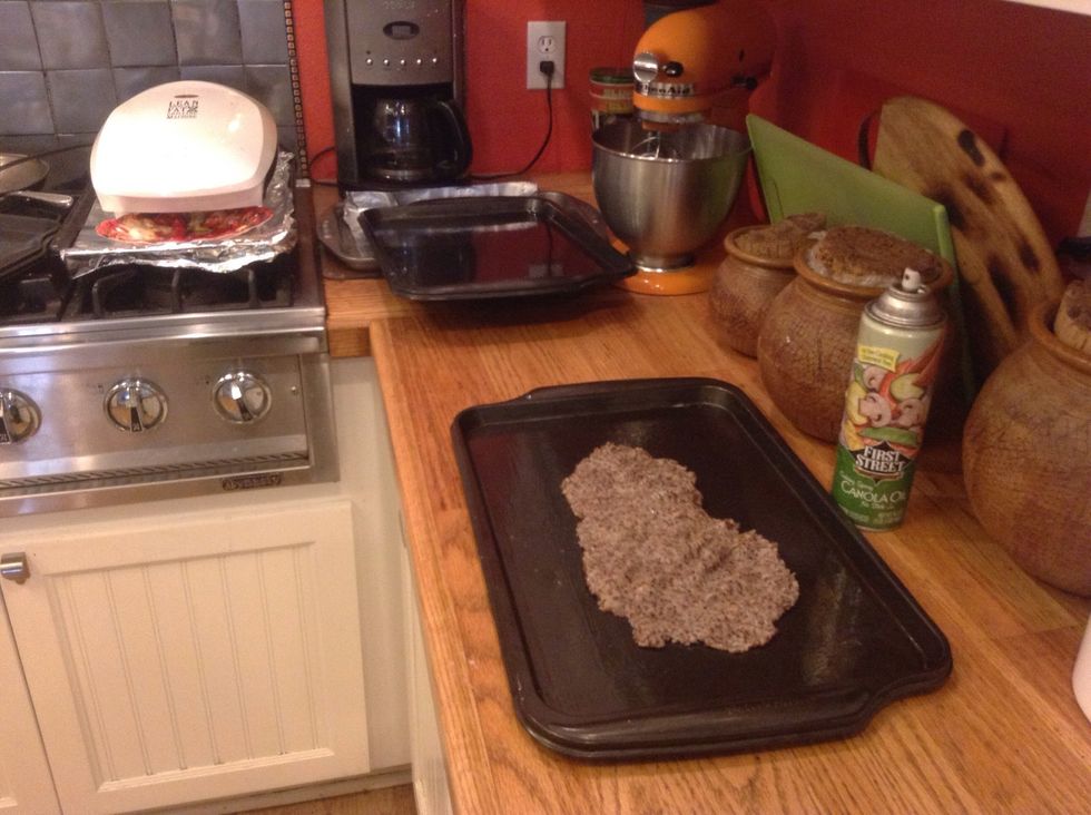 Plop about a cup of dough on baking sheet and spread to a thin layer, about 1/8 - 1/4 inch thick.