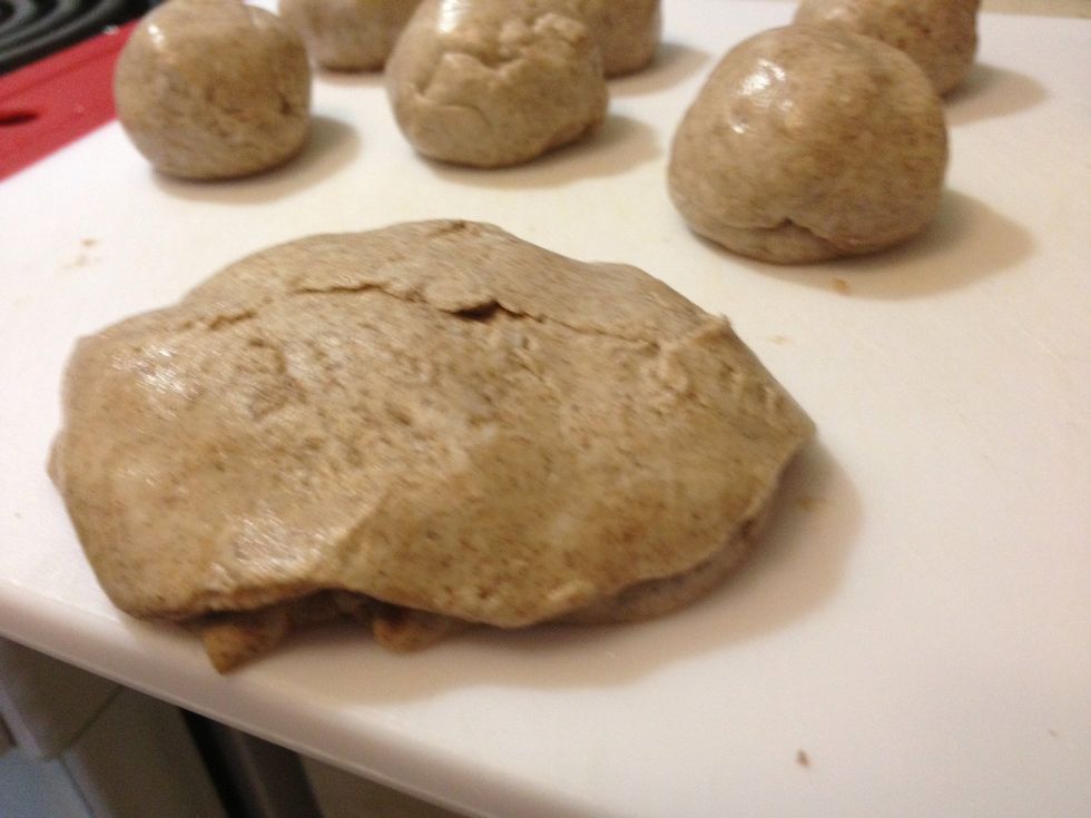 Plop one flatten dough on top.