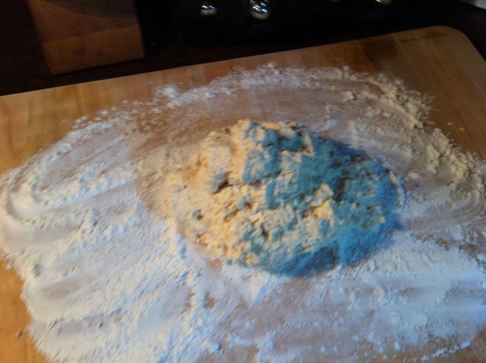 Plop that sticky goodness on the floured board.