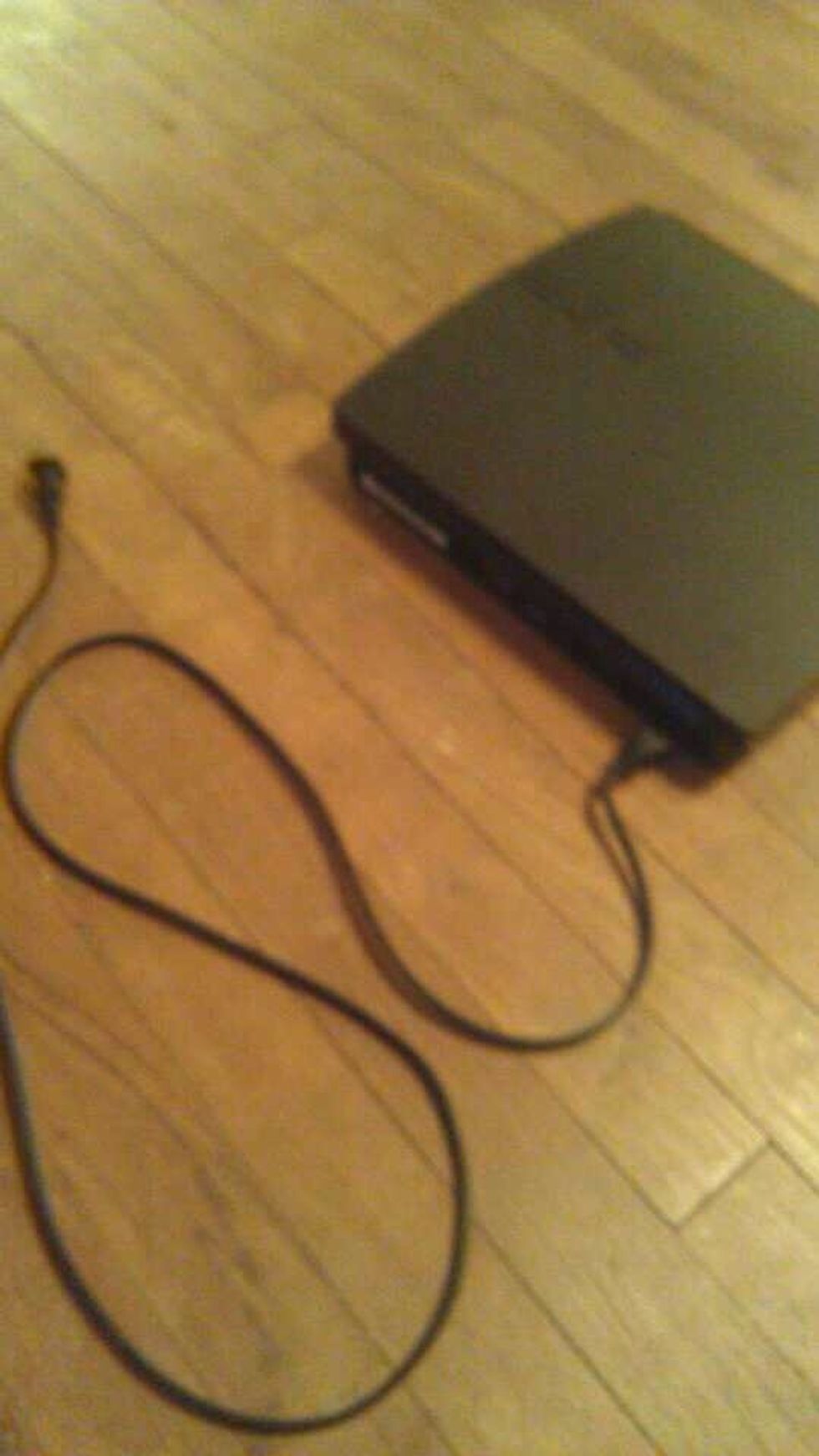 Plug in the power cord into the back of the console like so