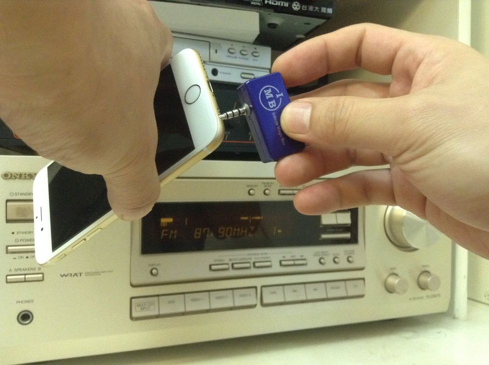 Plug in the transmitter to the audio jack of the iPhone 6 or iPhone 6 Plus