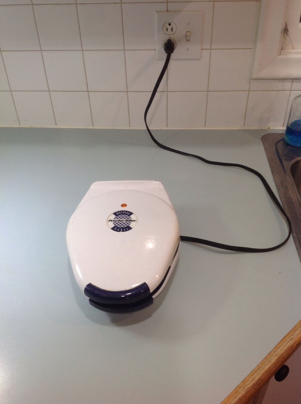 Plug in waffle iron to preheat