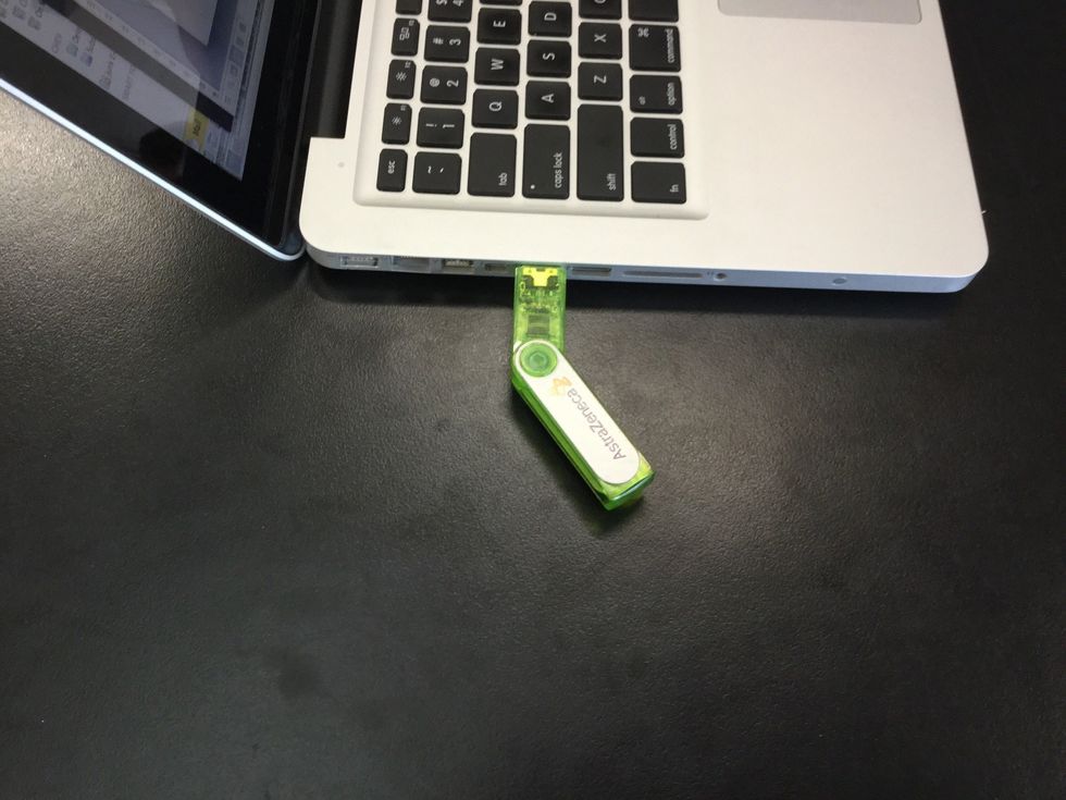 Plug in your USB into the USB port on the side of the computer