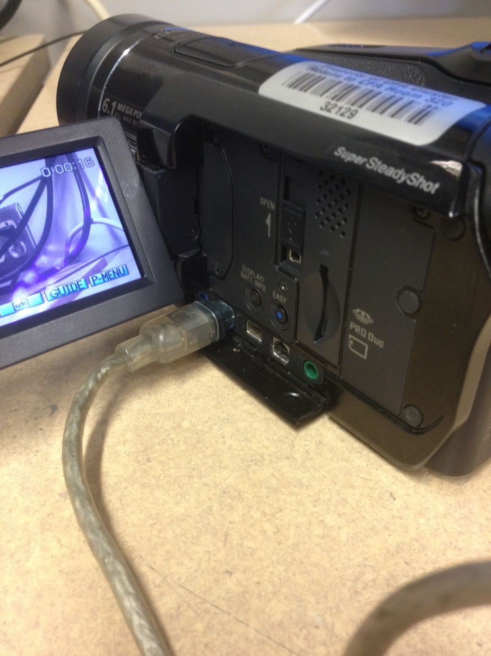 Plug the 4 to 6 pin FireWire 400 cable into the bottom left panel of the camcorder.